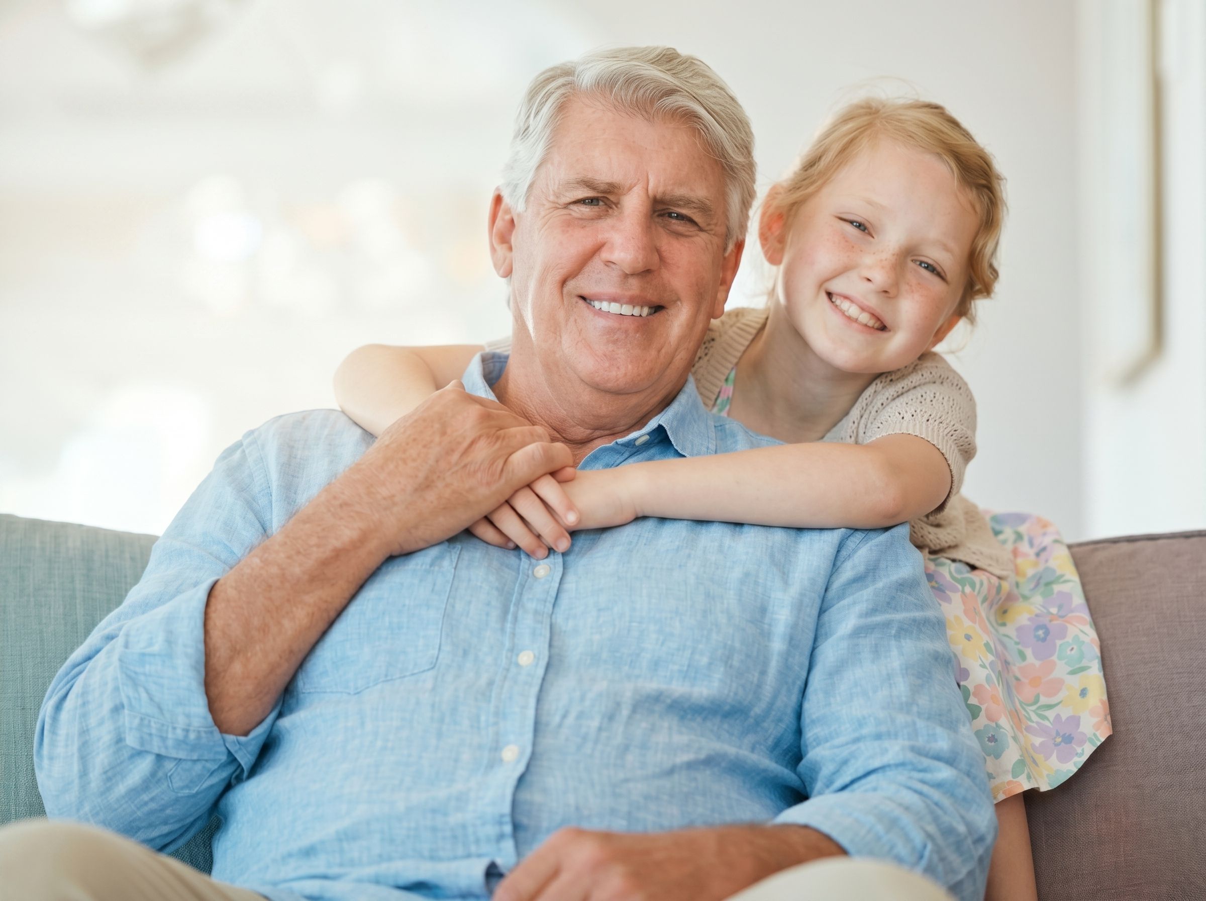 Grandfather and granddaughter smiling