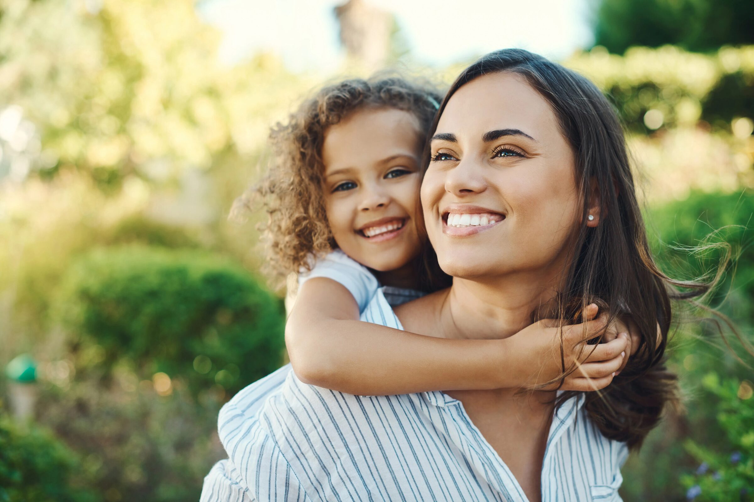 Mother and daughter smiling